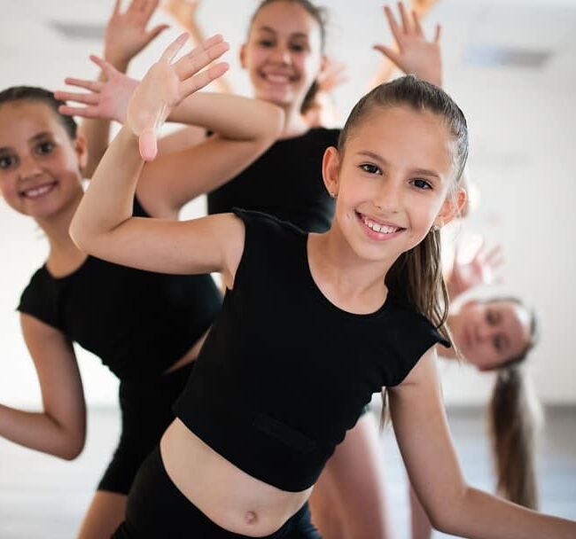 Choreographed dance by a group of young ballerinas practicing during class school